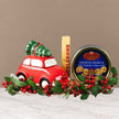 Christmas gift set with a red car, cookies, and Toblerone