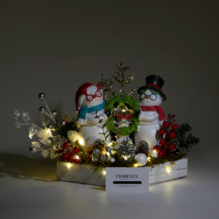 Arreglo navideño familiar de muñecos de nieve