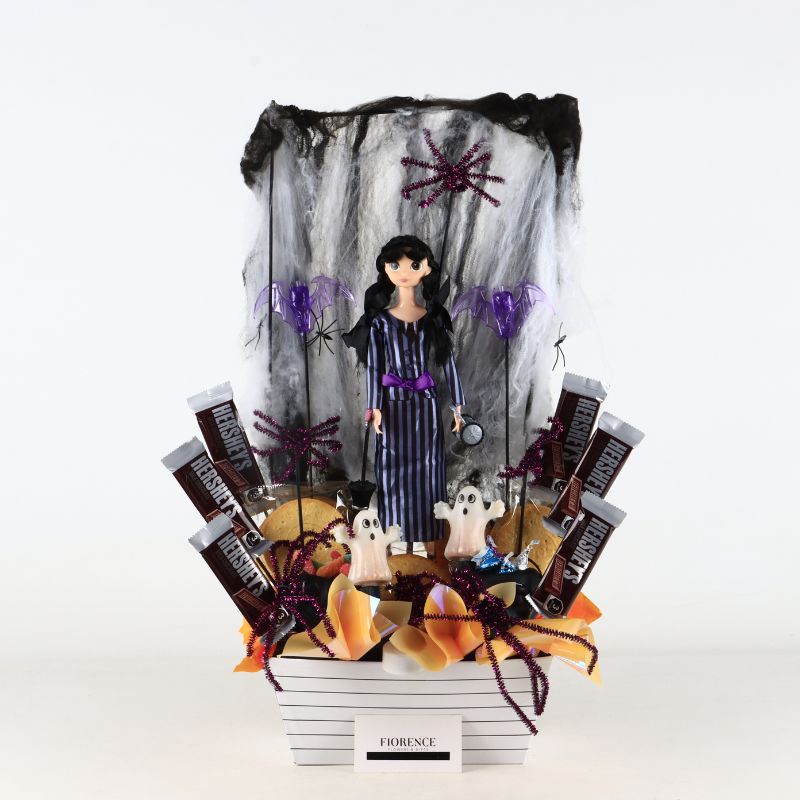 Halloween arrangement with Merlina doll, cookies and chocolates
